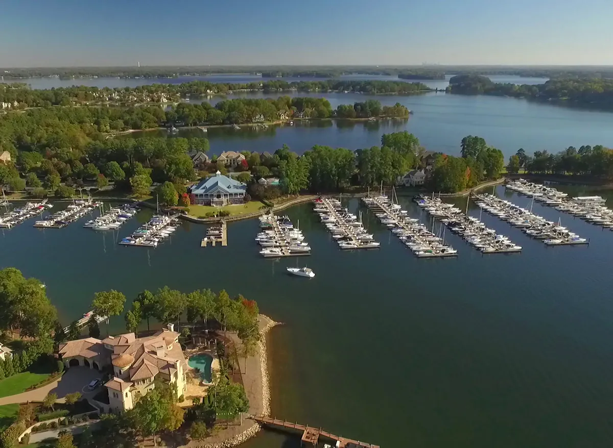 Aerial view of the Peninsula Yacht Club marina in Cornelius, with rows of sailboats and powerboats at the docks and Lake Norman stretching to the horizon